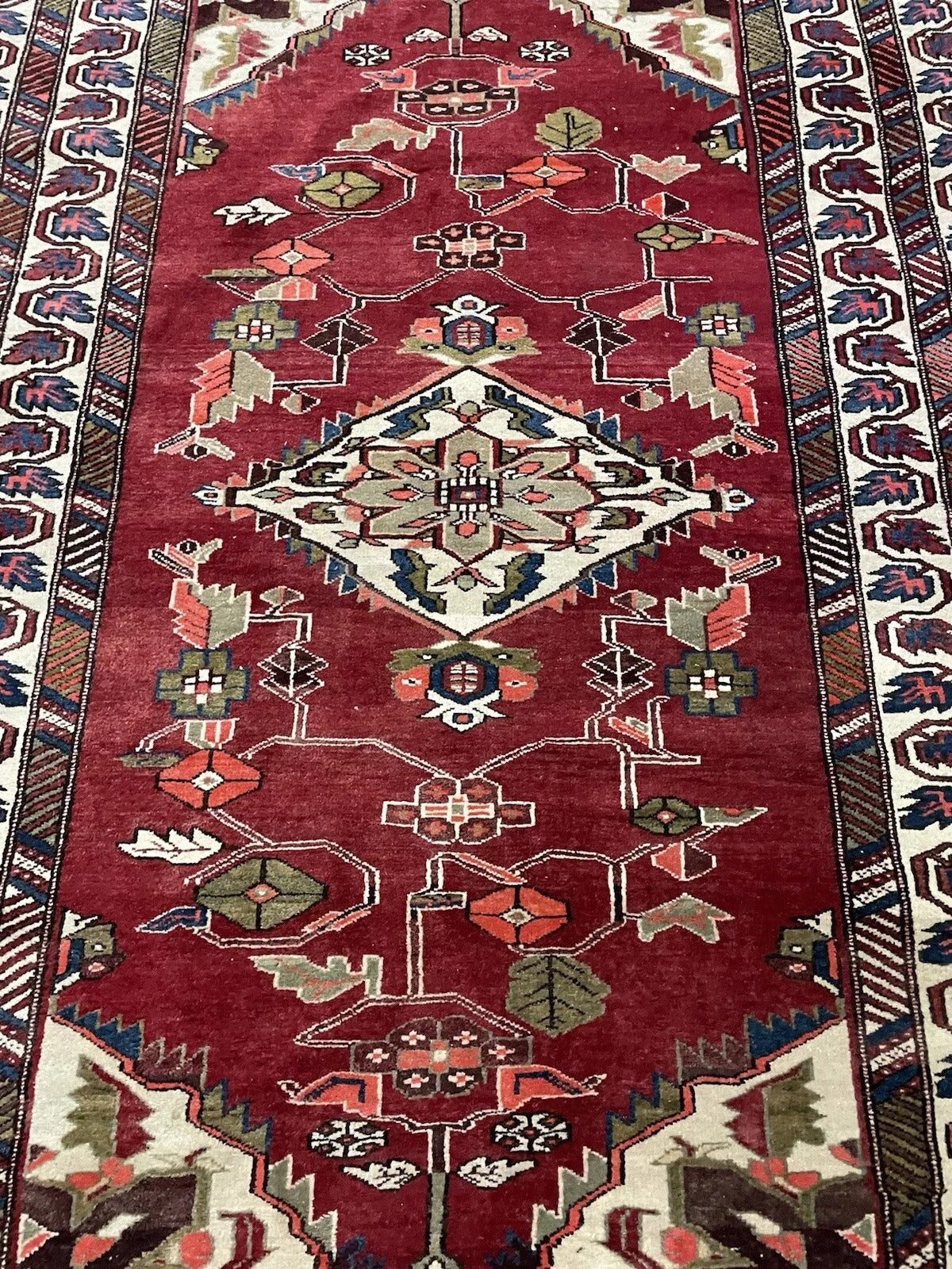 Handmade Persian wool rug with traditional design.

