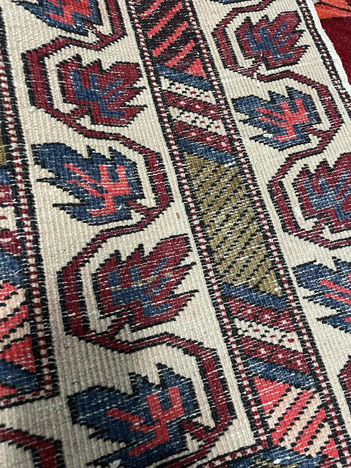 Close-up of Persian rug border with floral detailing.

