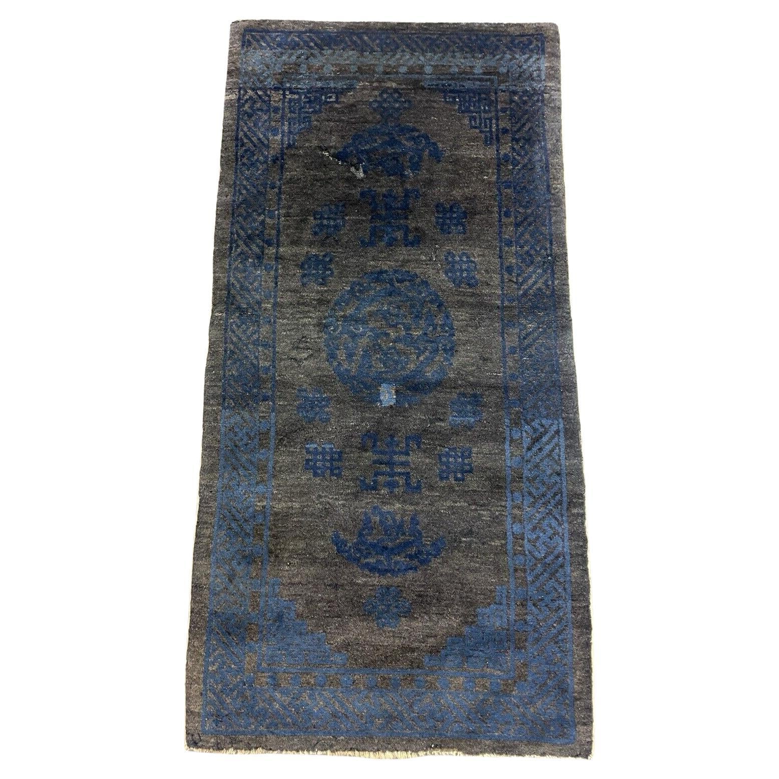 Handmade antique Peking Chinese rug with deep blue geometric patterns.

