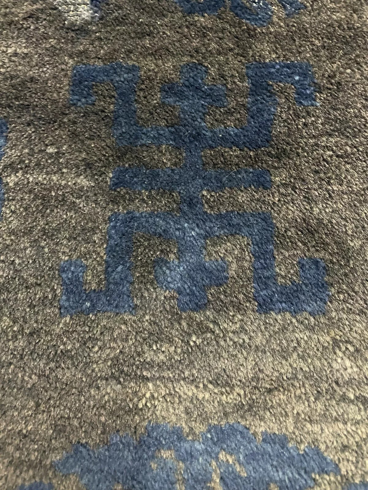Traditional Chinese geometric motifs on an antique rug.

