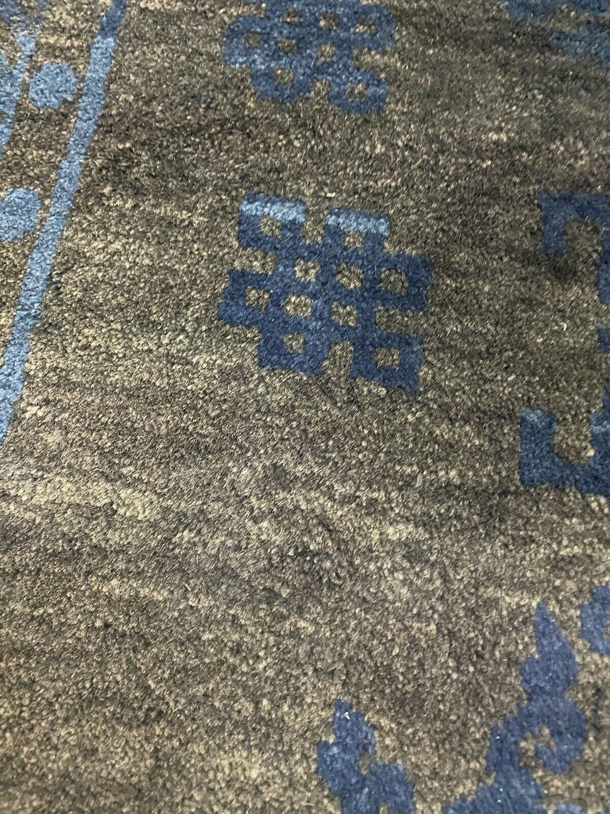 Close-up of geometric designs on antique Peking rug.

