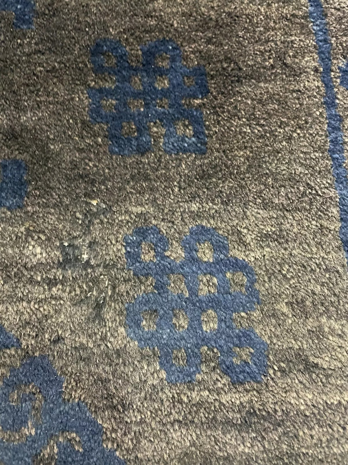Dark blue antique rug with an elegant Chinese border.


