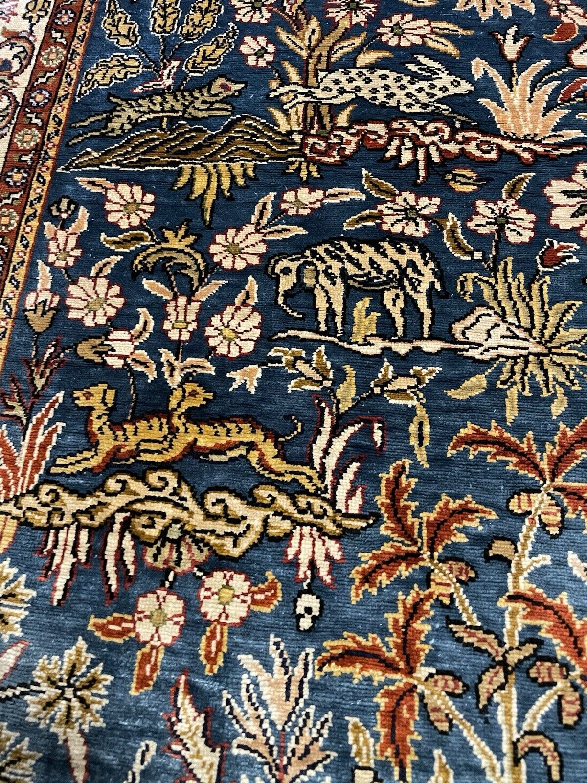 Fine Hereke silk rug with floral designs and soft fringes.

