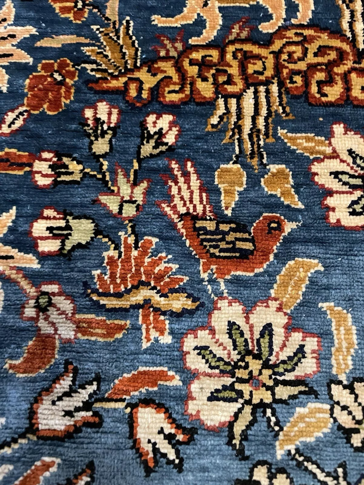 Handmade Turkish rug reflecting light with its silk texture.


