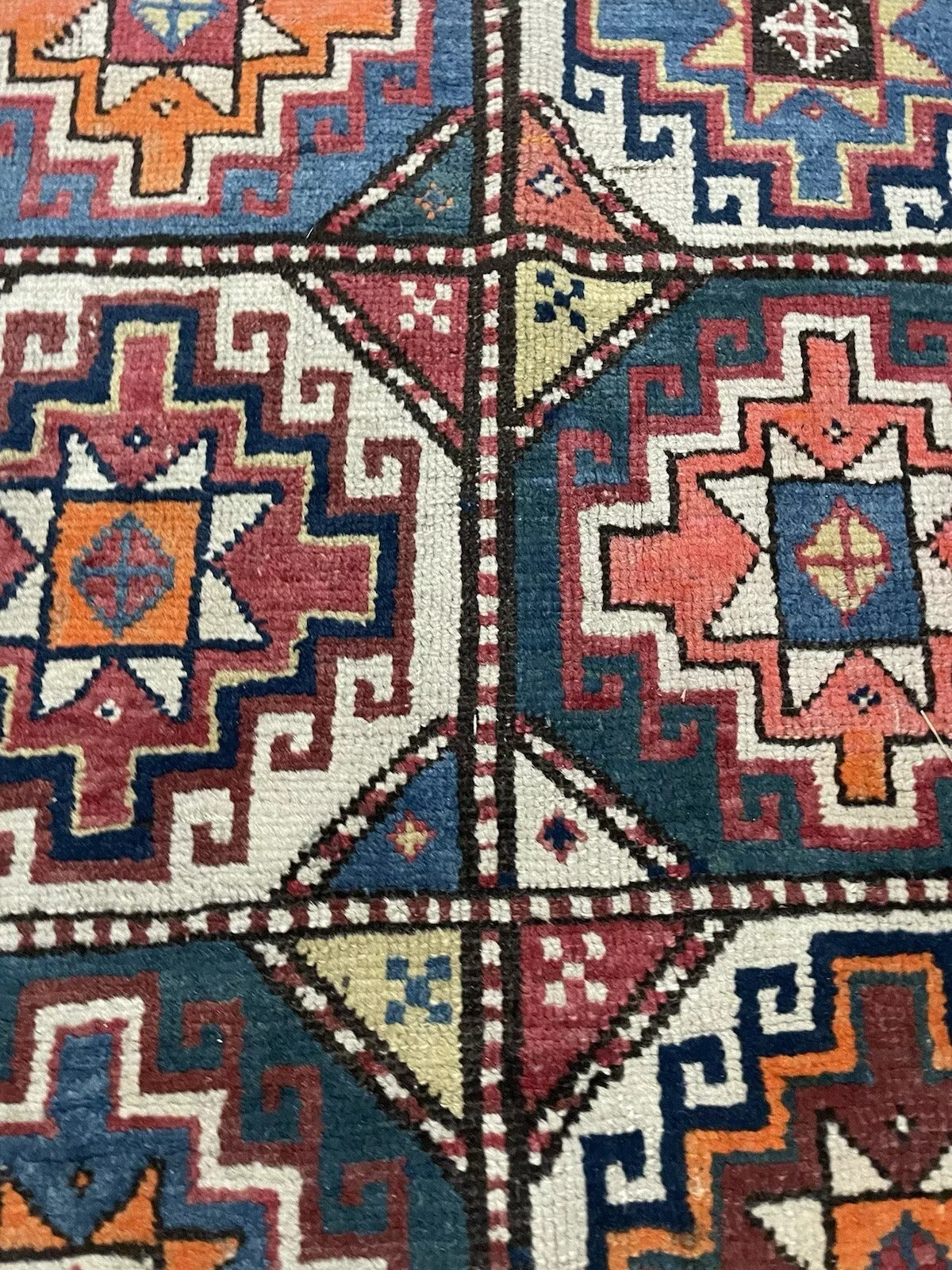Detailed border of a handmade antique Caucasian wool carpet.

