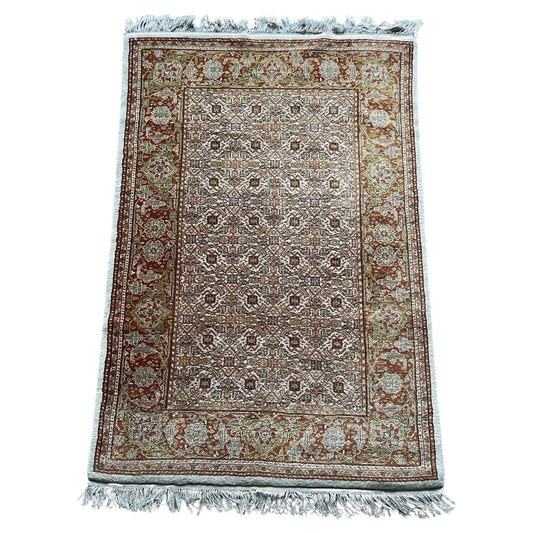 Handmade vintage Indian Agra wool rug with floral patterns.

