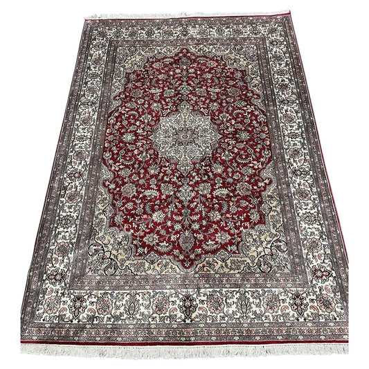 Full view of handmade vintage Persian silk Qum rug in cream and red

