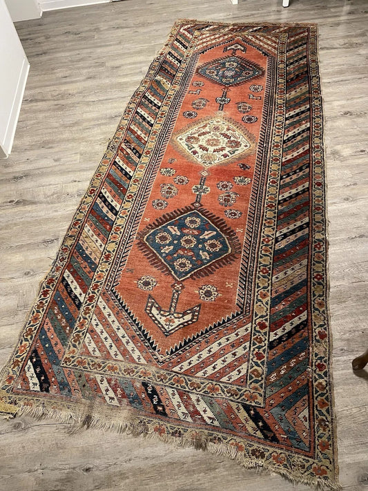 Long narrow Kurdish runner rug with repeating geometric motifs

