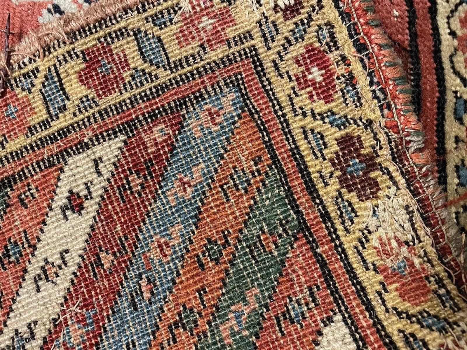 Indigo and red motif close-up on 19th-century Kurdish rug

