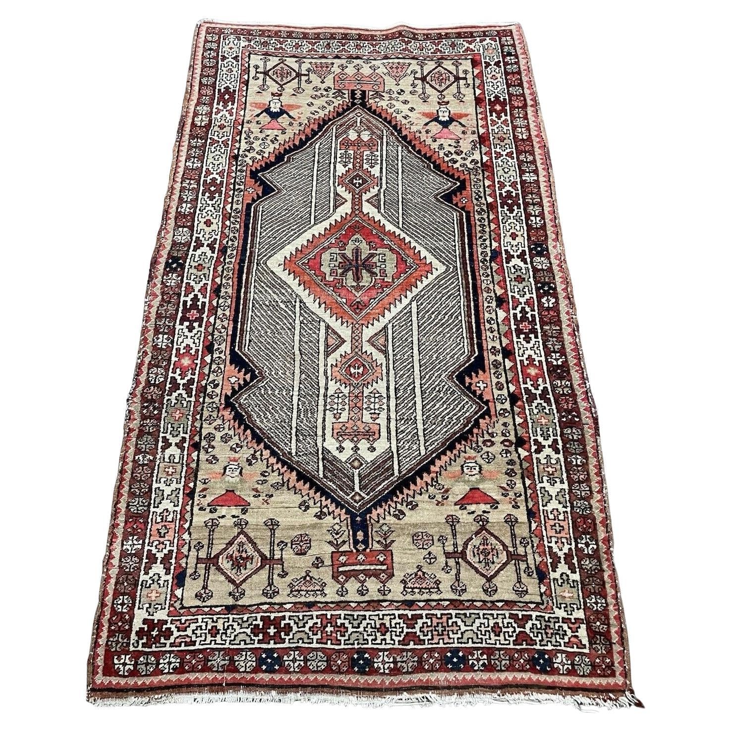 Antique Persian Seraband rug featuring repeating boteh motifs on straw‑sand field

