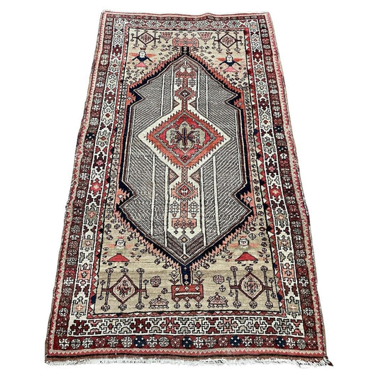 Antique Persian Seraband rug featuring repeating boteh motifs on straw‑sand field

