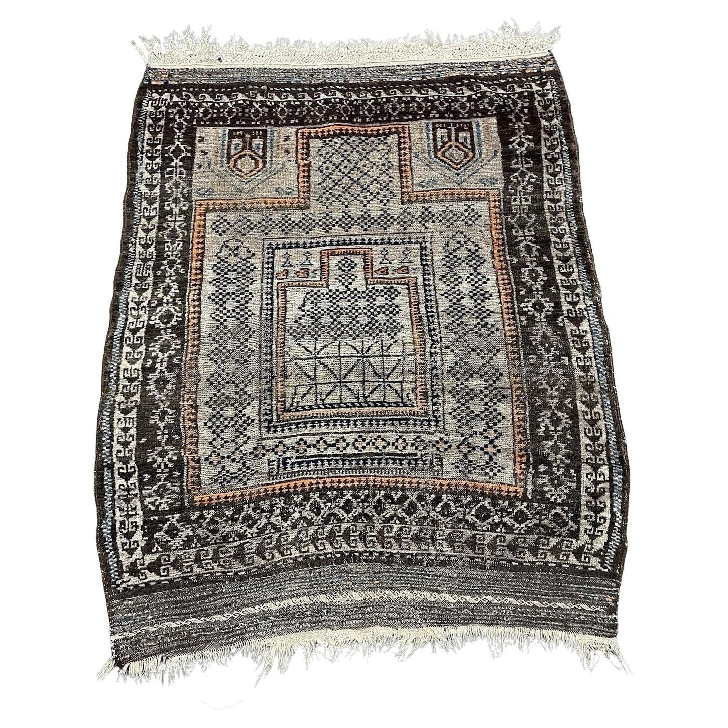 Antique Afghan Baluč rug with rust red and indigo medallions

