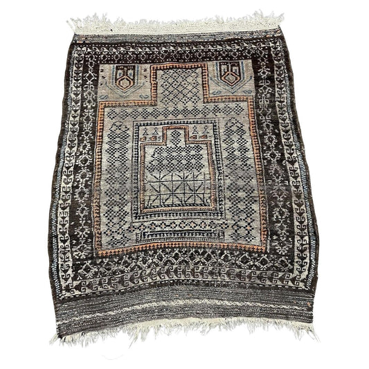 Antique Afghan Baluč rug with rust red and indigo medallions

