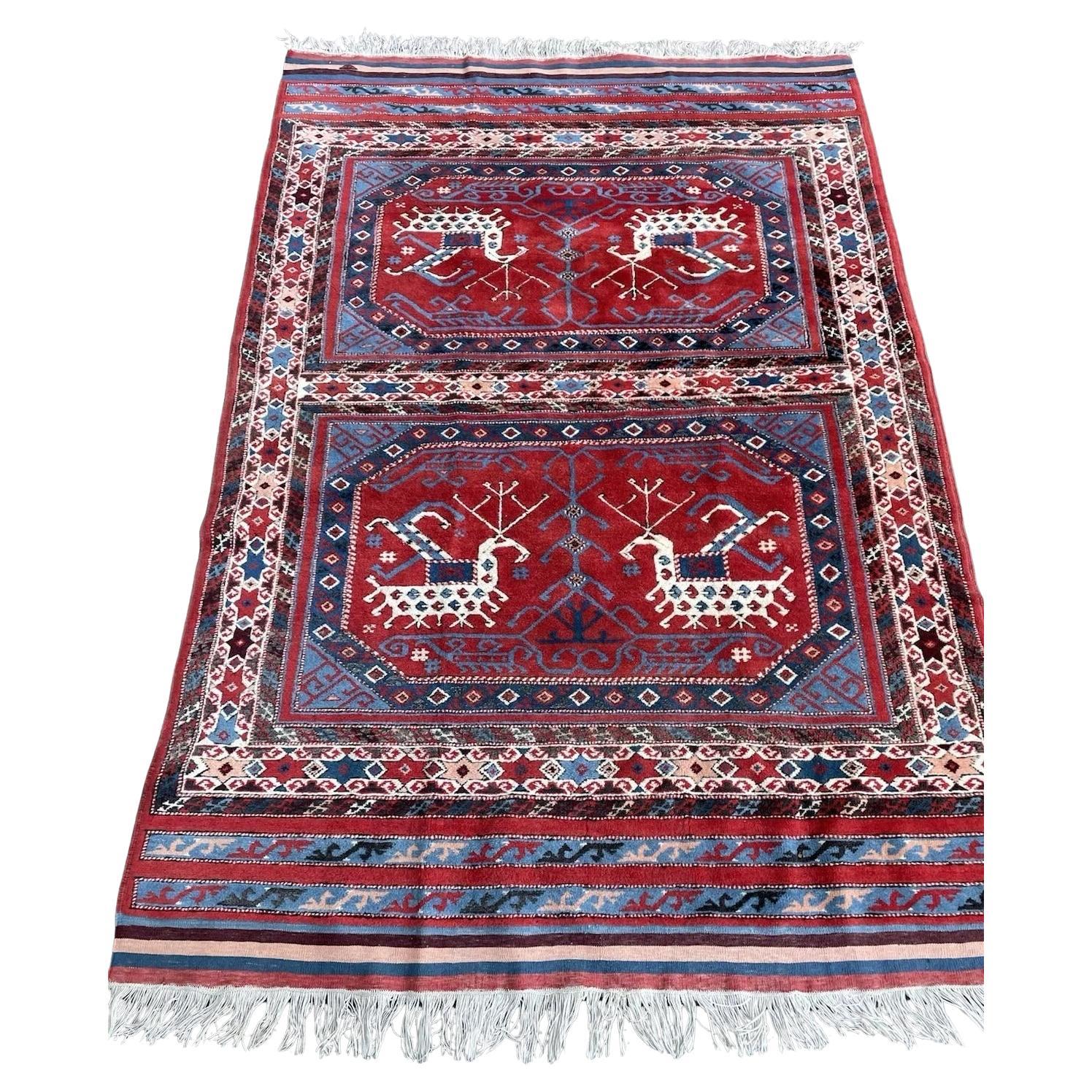 Vintage Yörük rug in deep red with animal motif

