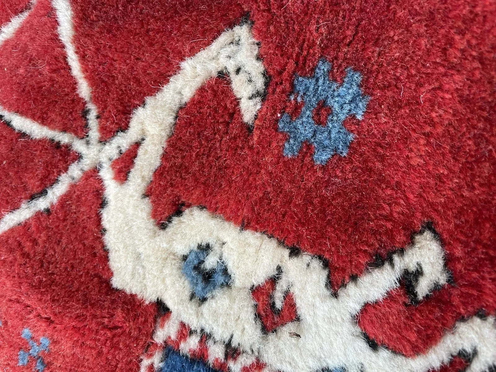 Stylized animal figure on red field of Anatolian rug

