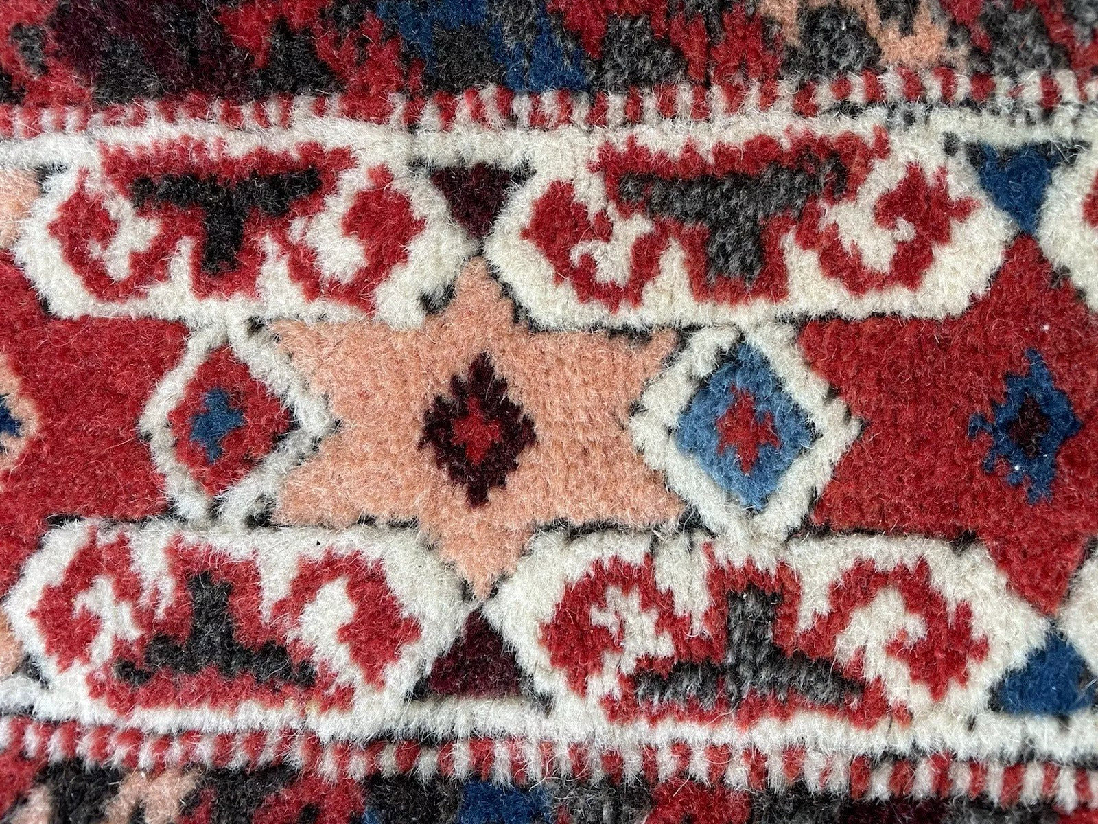 Bold red central field framed by geometric borders

