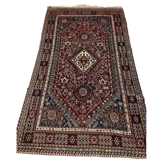 Antique Persian Gashkai rug with bold medallion design

