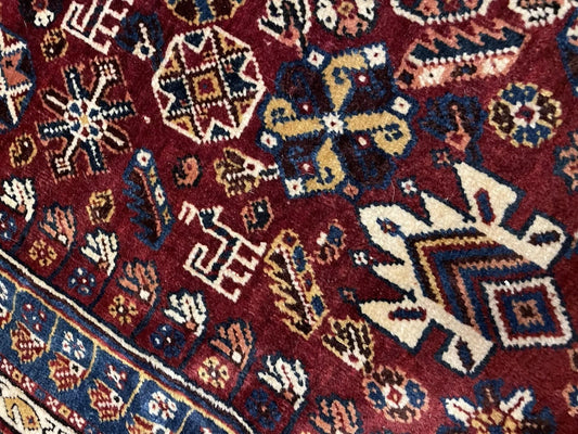 Close-up of stylized animal figures on wool rug

