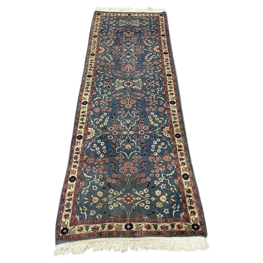Handwoven Persian Kerman runner rug with intricate floral medallions
