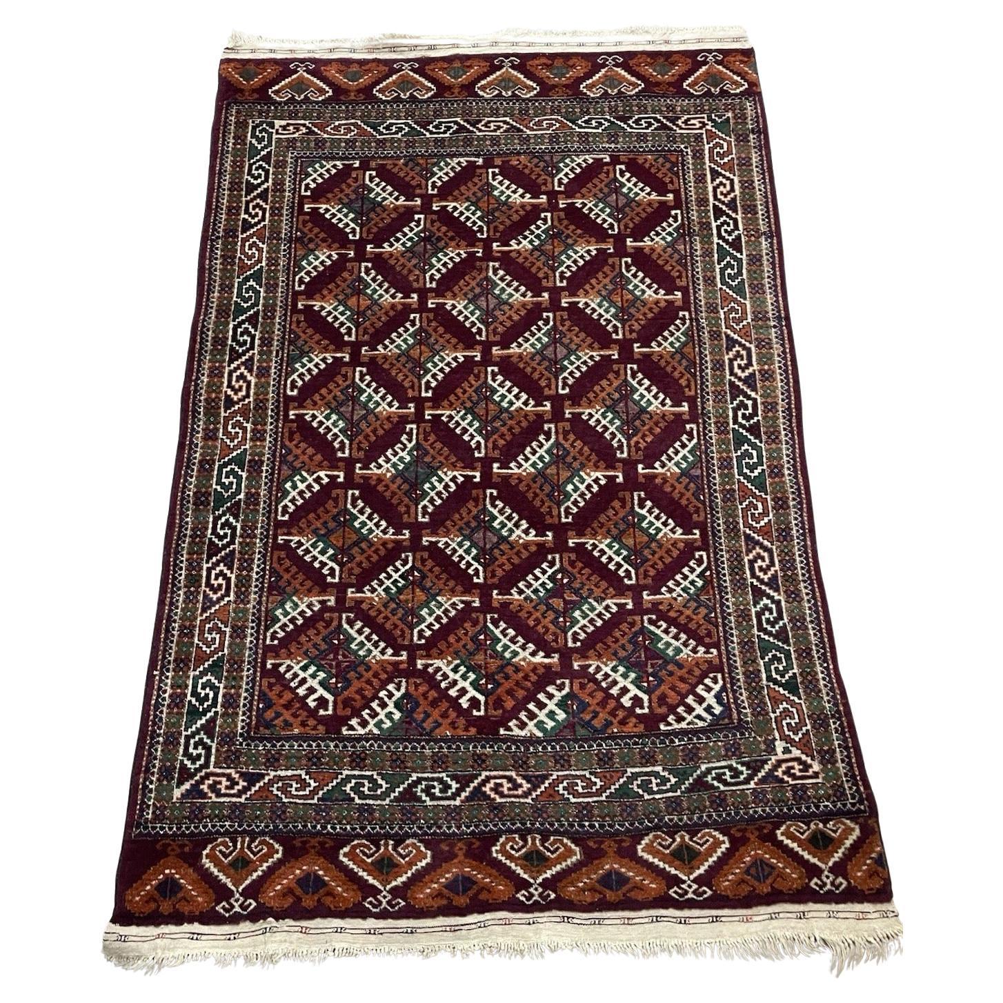 Burgundy Turkmen Yomud rug with geometric gul motifs
