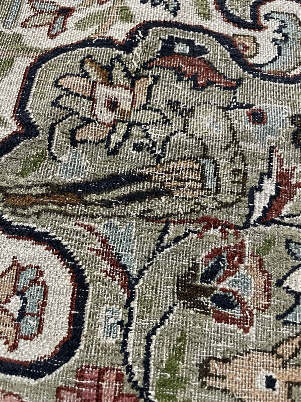 Close-up on the faded terracotta and earth tones within the design.

