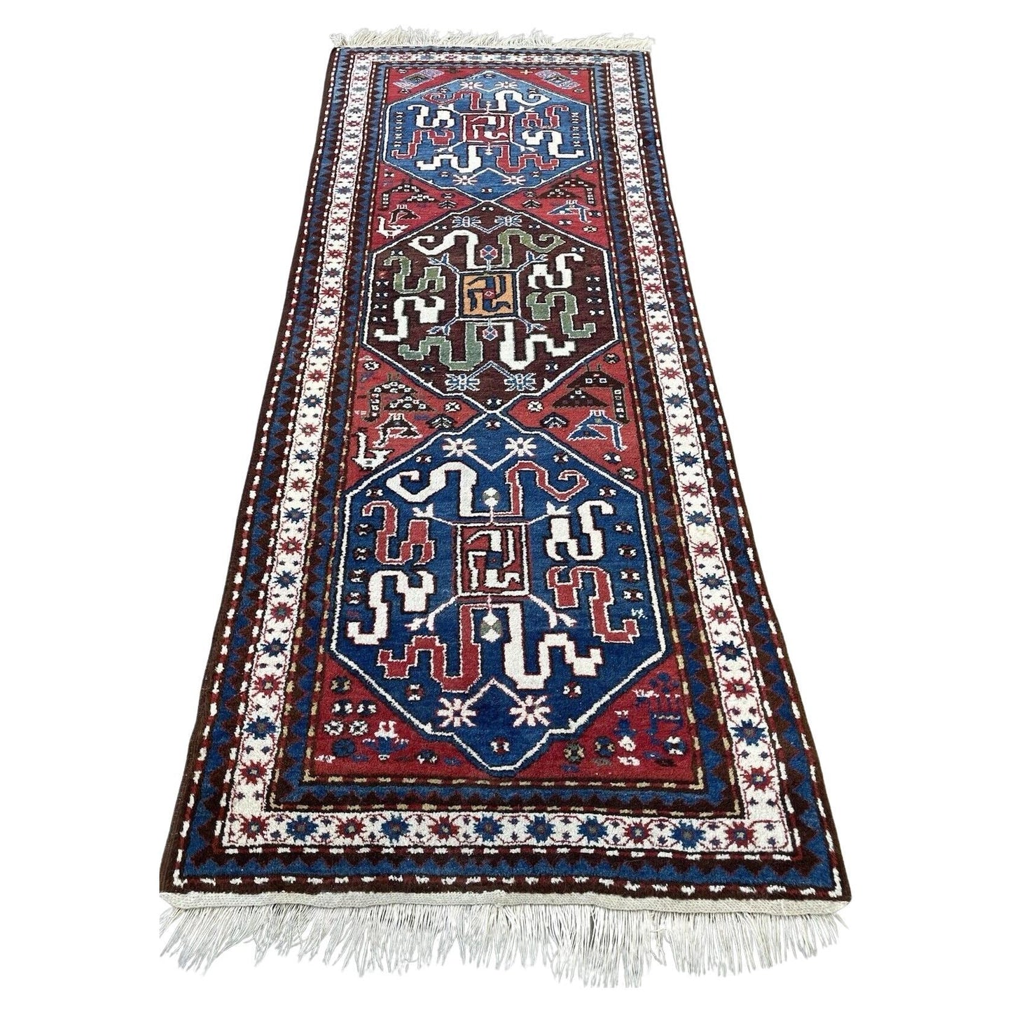 Full top view of the antique Caucasian Kazak rug showing the two large medallions on a red field.

