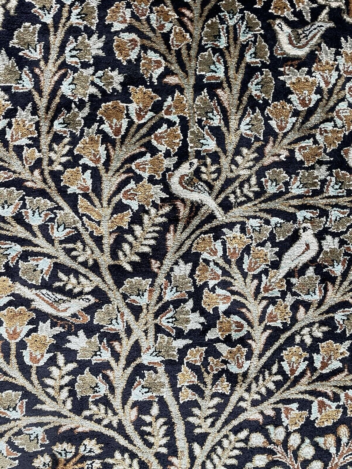 A section of the rug showcasing the harmony between the animals and the flora.

