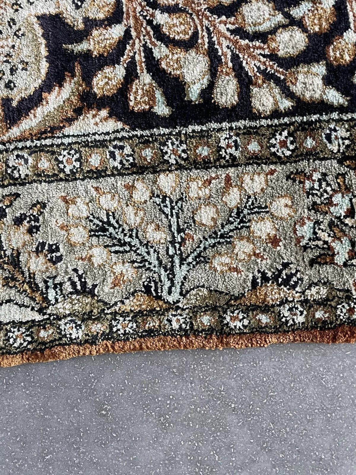 Detail of the intricate floral and foliage patterns surrounding the animals.

