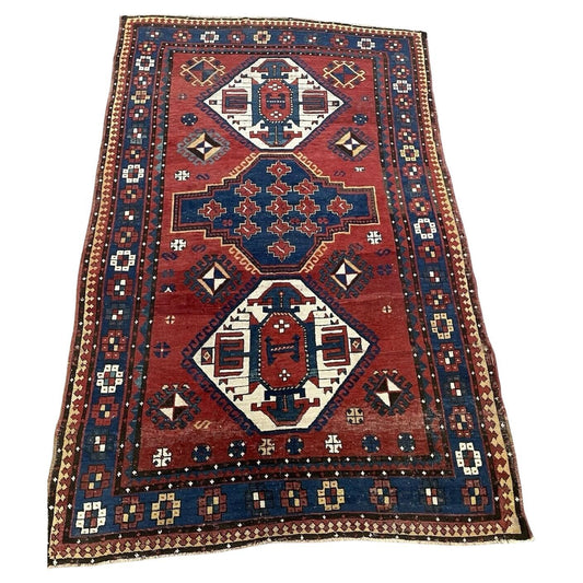 Full top view of the antique Caucasian Lori Pambak rug showing the central and flanking medallions.

