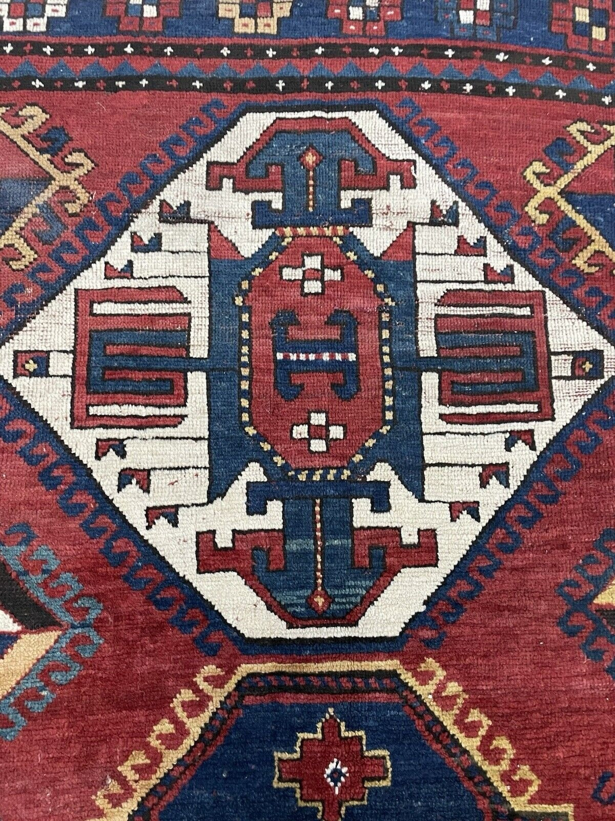 A section of the rug showcasing the dynamic balance between the medallions.

