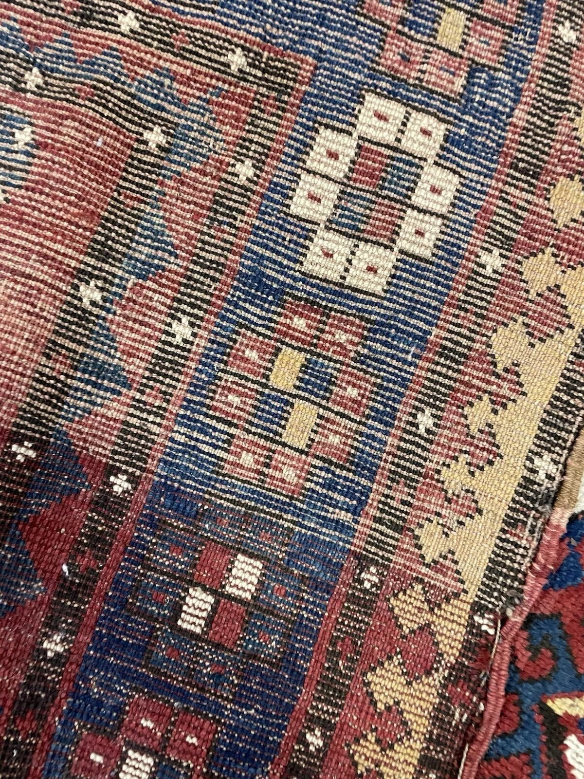 Detail of the smaller geometric symbols and motifs filling the field.

