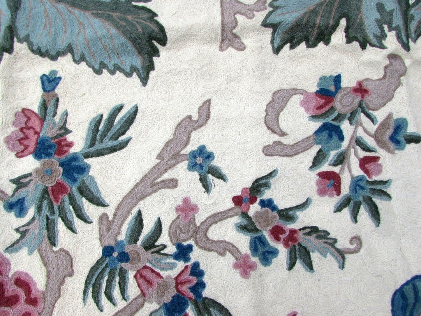 Detailed close-up of the intricate floral pattern on the Indian rug
