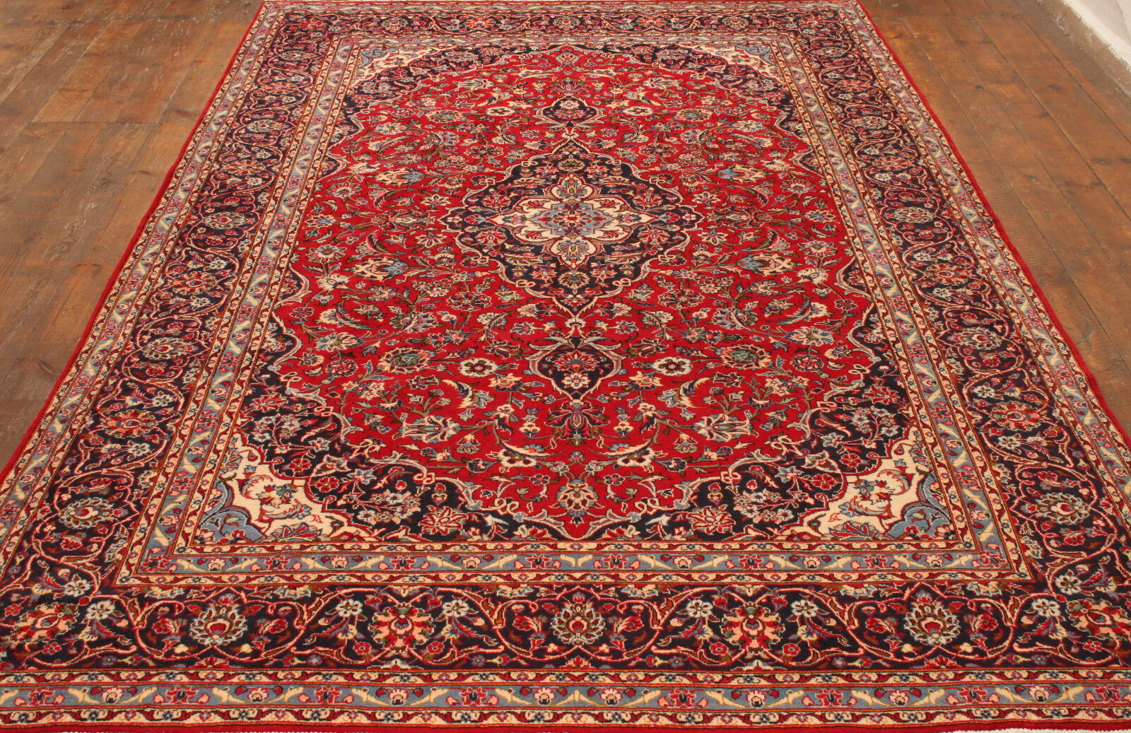 Angled shot of the Handmade Vintage Persian Style Kashan Rug complementing furniture