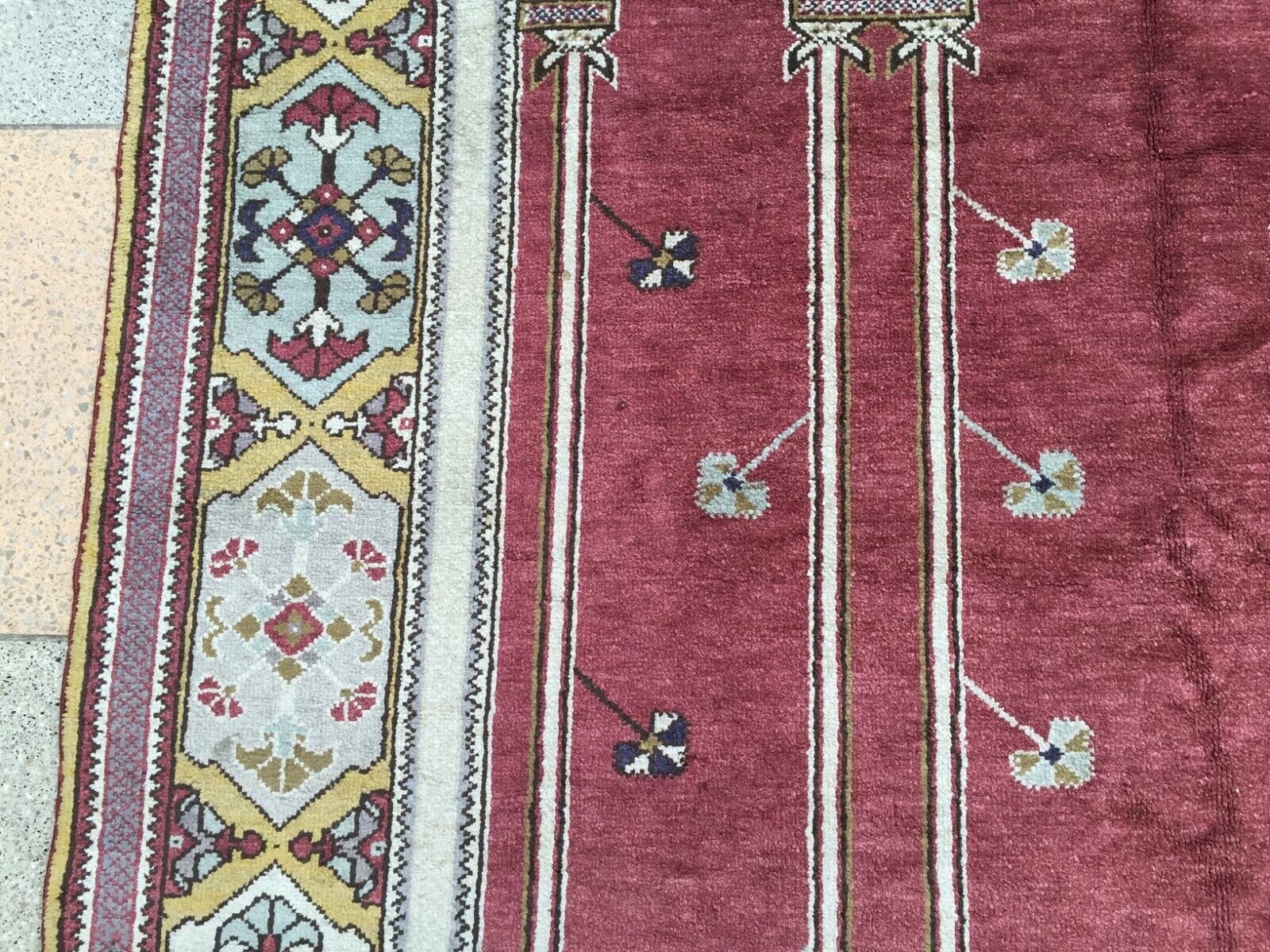 Side angle view of the rug, emphasizing its high-quality wool material and excellent vintage condition