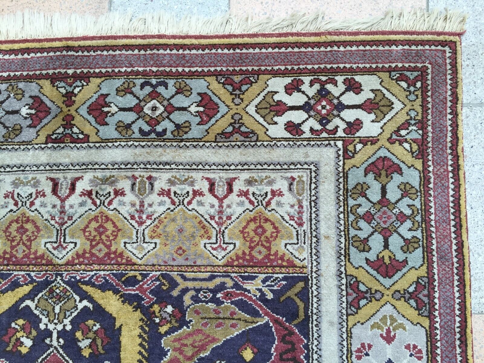 Front view of the rug hanging elegantly, capturing its full dimensions and design