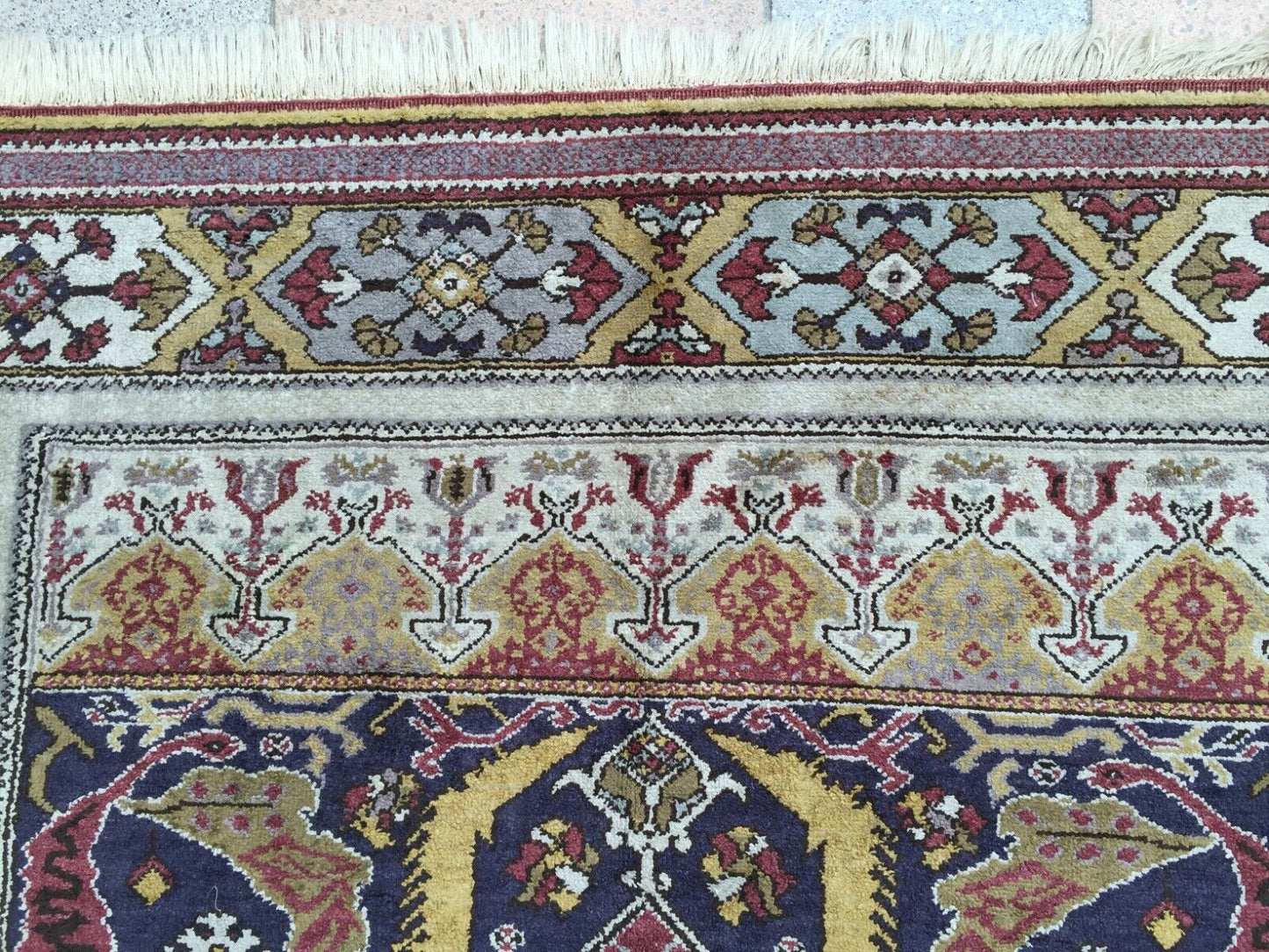 Artistic display of the rug on a floor, showcasing its cultural significance and vintage charm