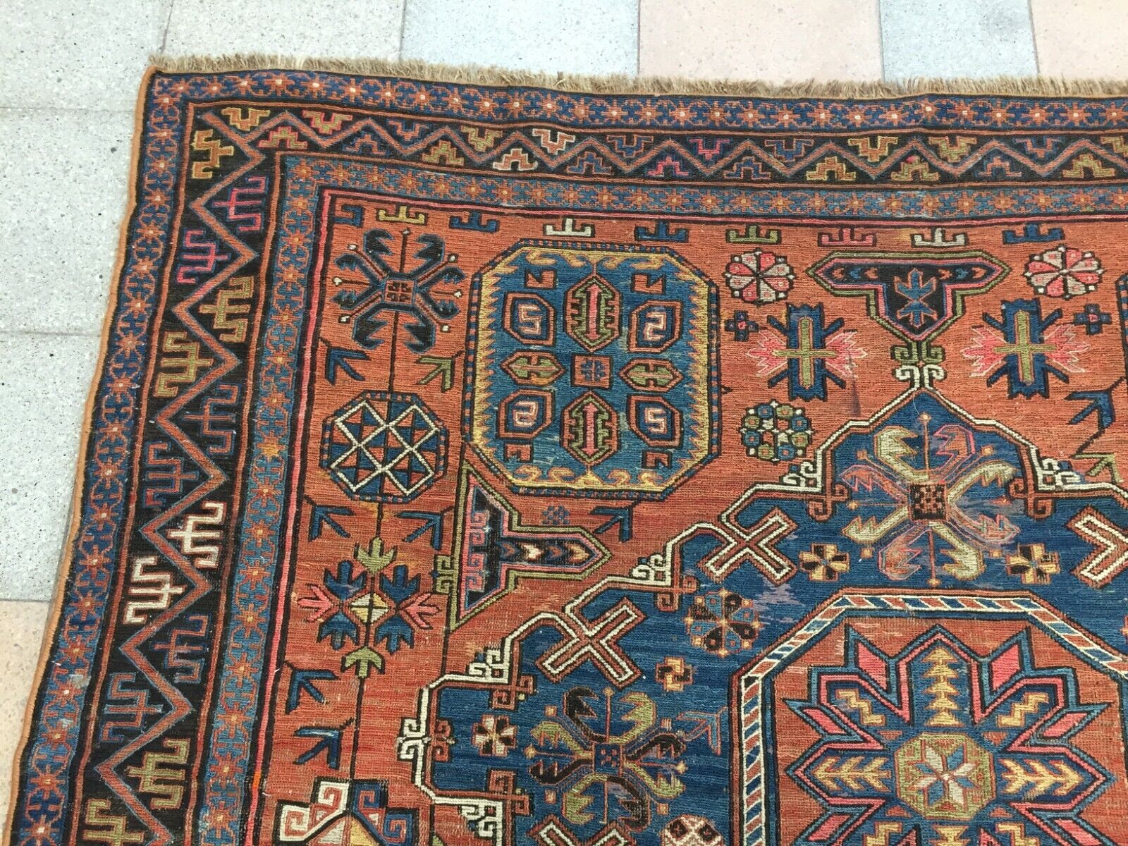 Detailed view of the rug's corner, revealing its craftsmanship and quality wool material