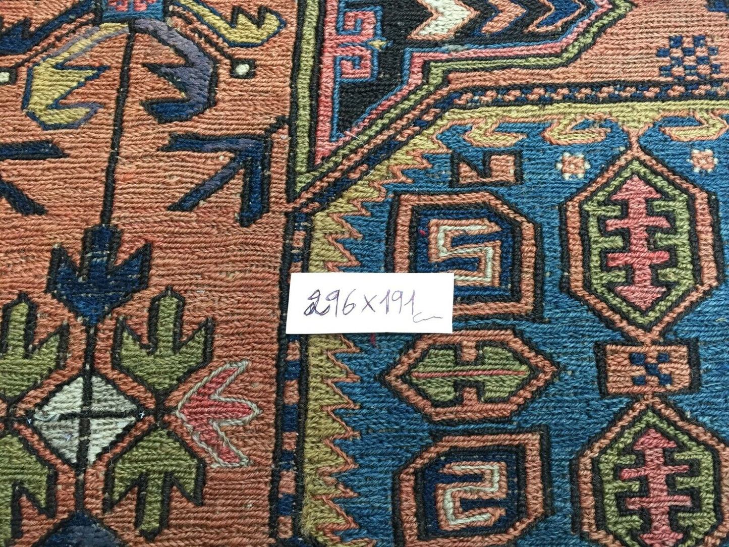 Front view of the rug hanging elegantly, capturing its full dimensions and design