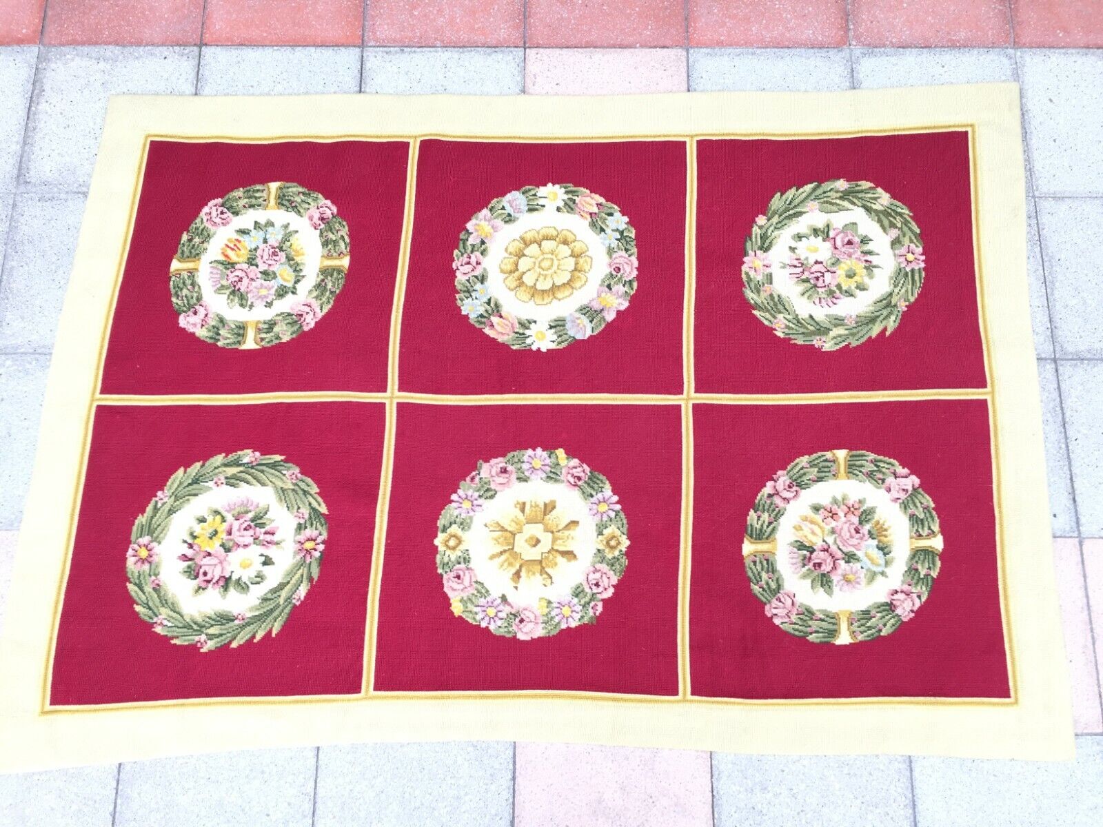 Close-up of the central red area with intricately needlepointed circular floral designs