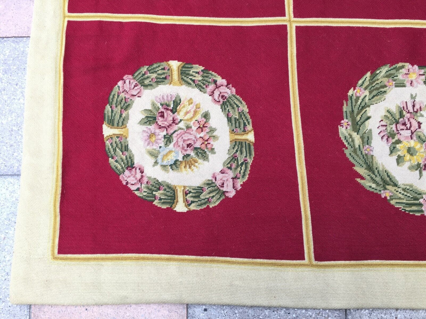 Overhead shot of the rug displaying its symmetrical arrangement of floral motifs
