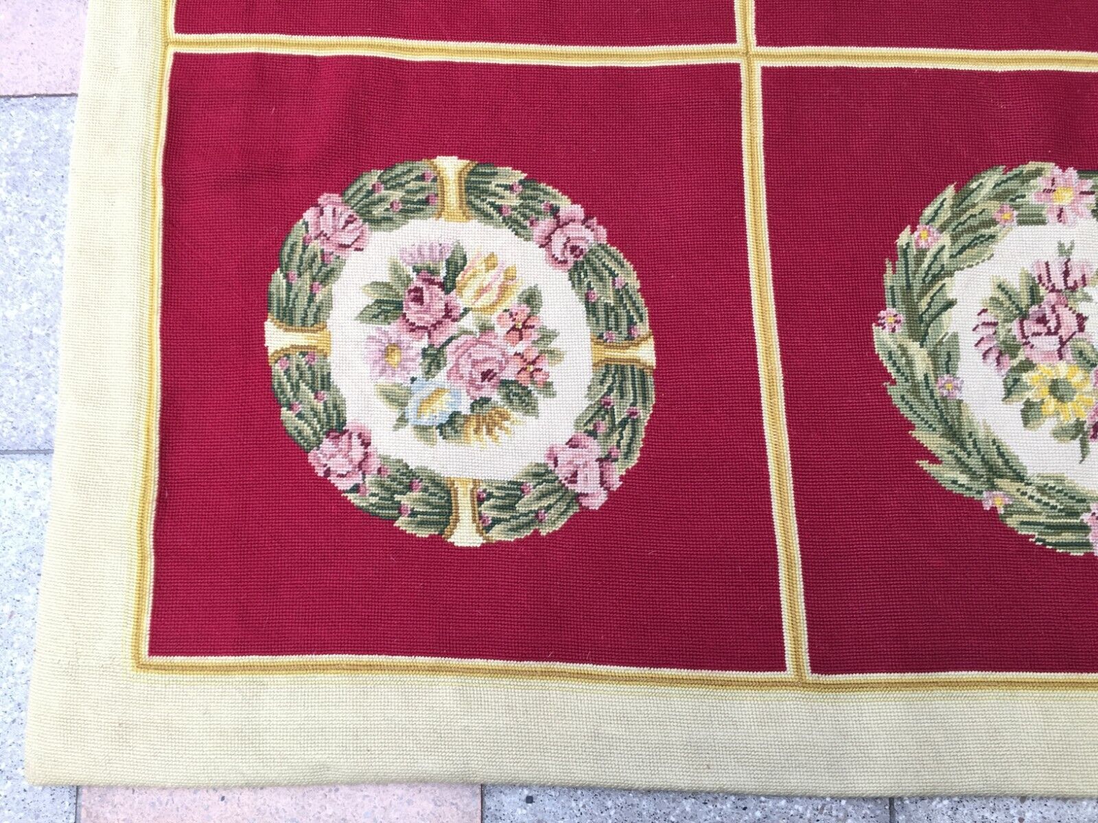 Overhead shot of the rug displaying its symmetrical arrangement of floral motifs
