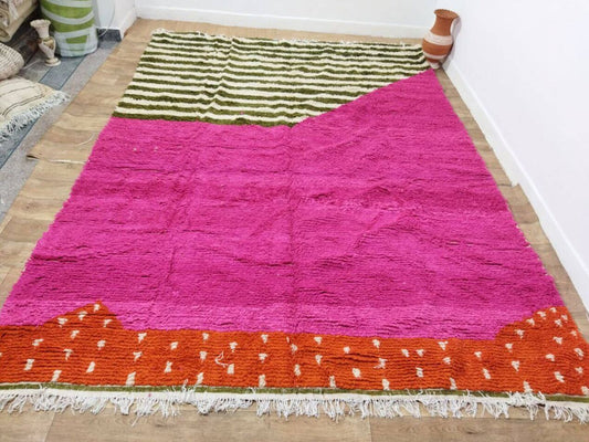 Close-up of geometric tribal motifs overlaying pink and orange sections

