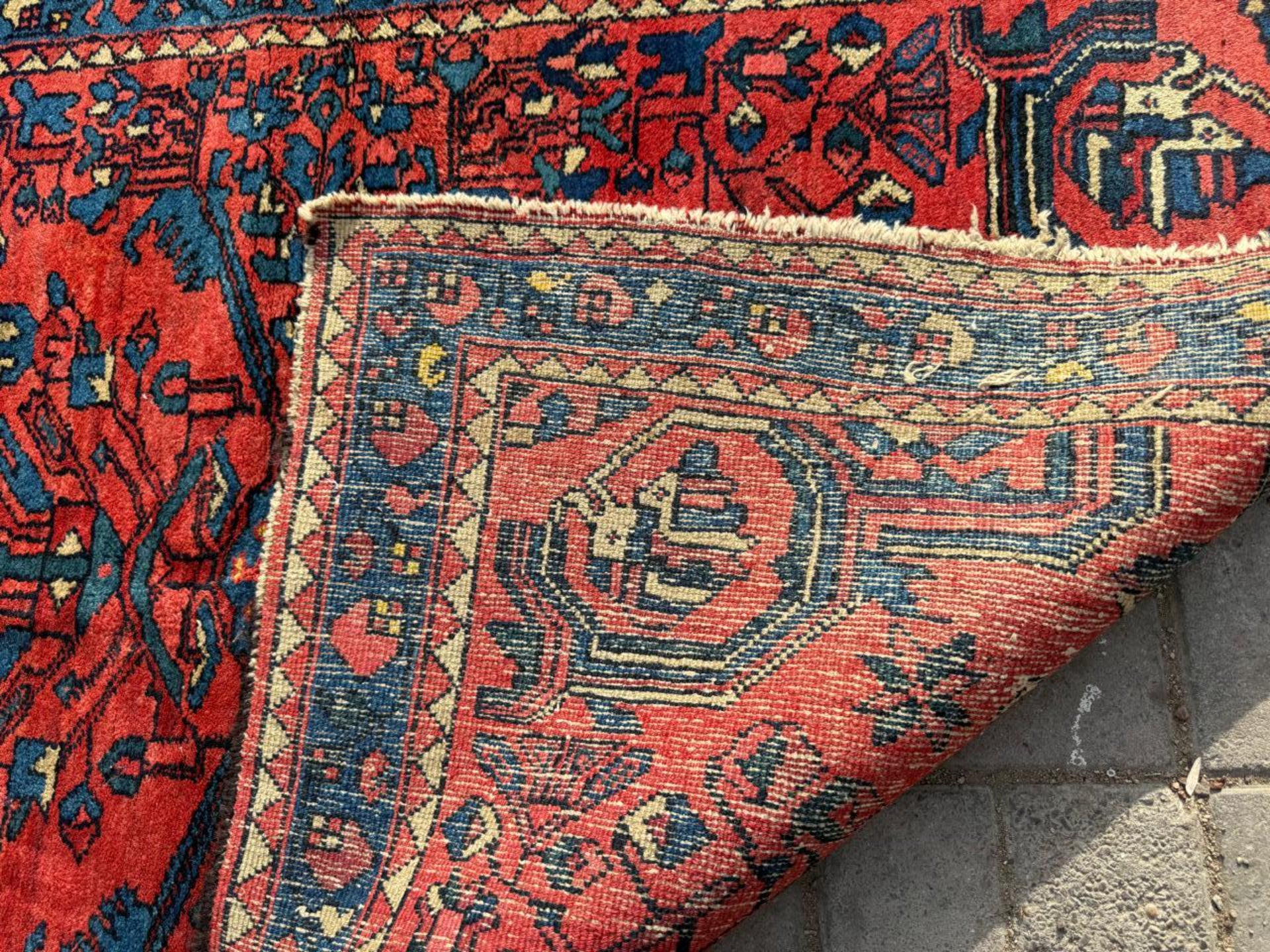 Close-up of stylized floral sprays surrounding medallion

