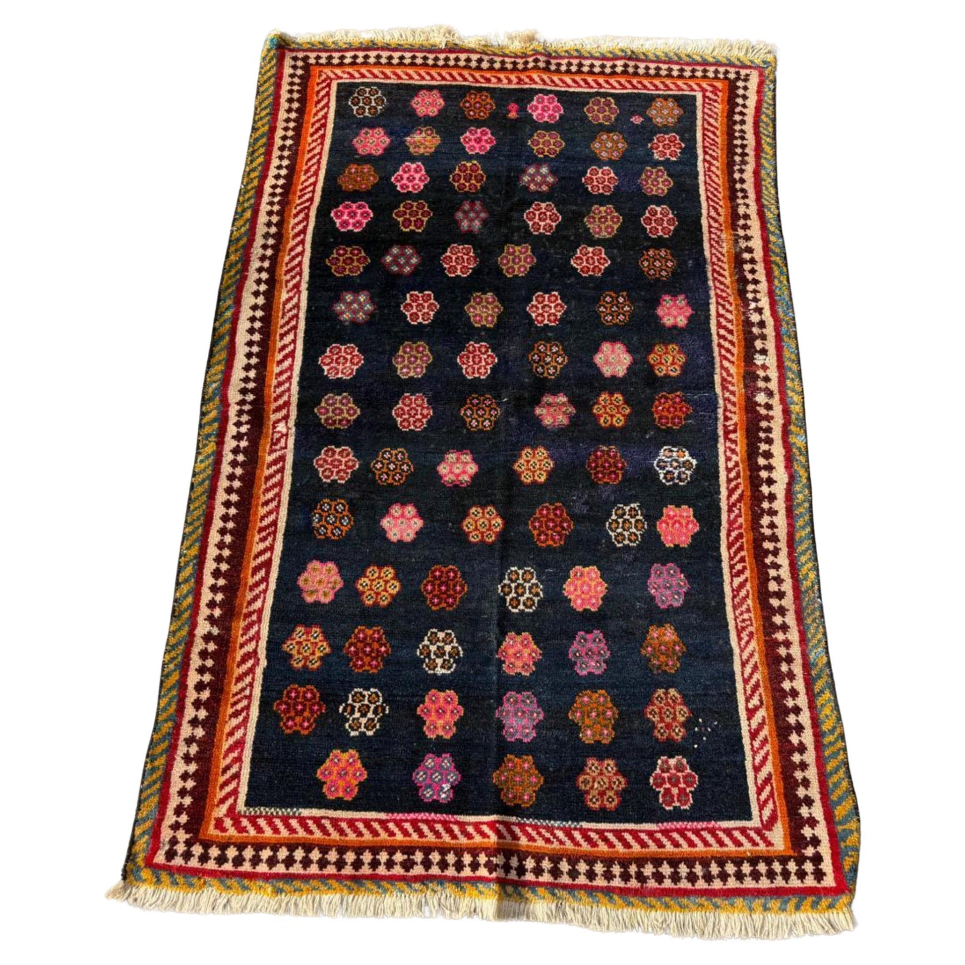 Antique Luri rug with scattered medallions on navy field


