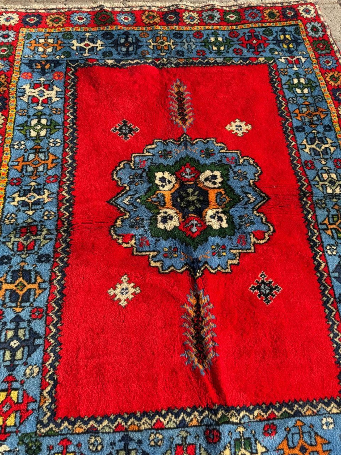 Pillarbox red field with indigo blue central motif


