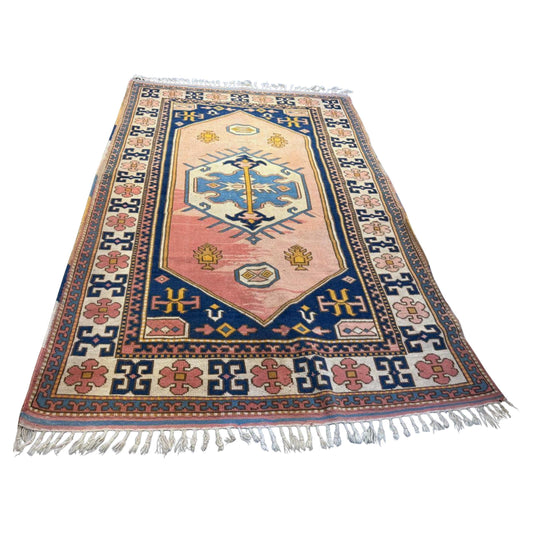 Vintage Anatolian rug with central geometric medallion

