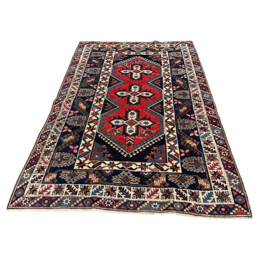 Full front view of the antique Bergama rug showing its large geometric medallions.

