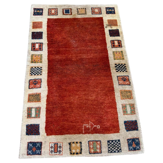 Full front view of the vintage Gabbeh rug showing its minimalist design.

