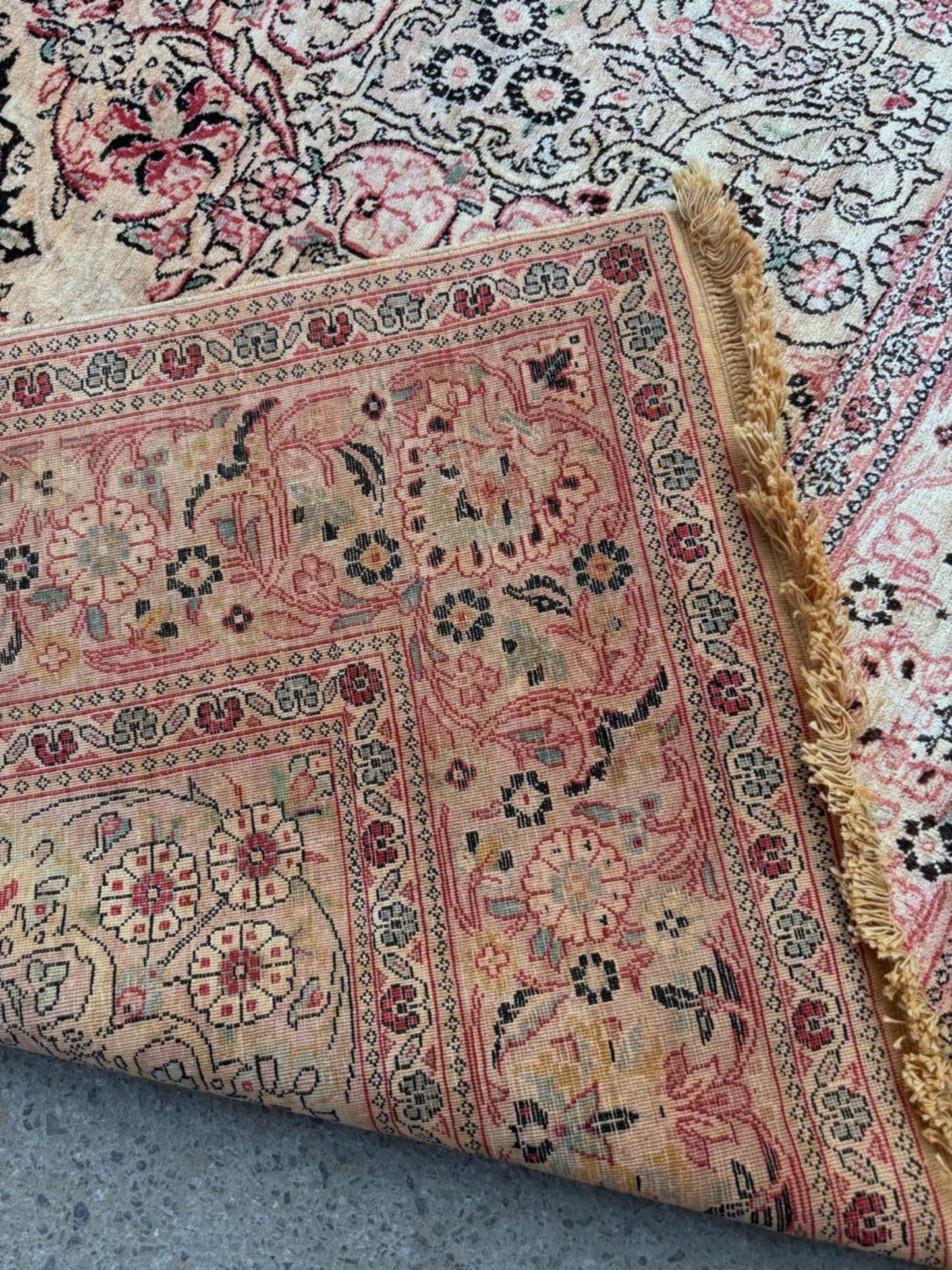 Close-up detail of an intricate boteh (paisley) motif with internal floral details.


