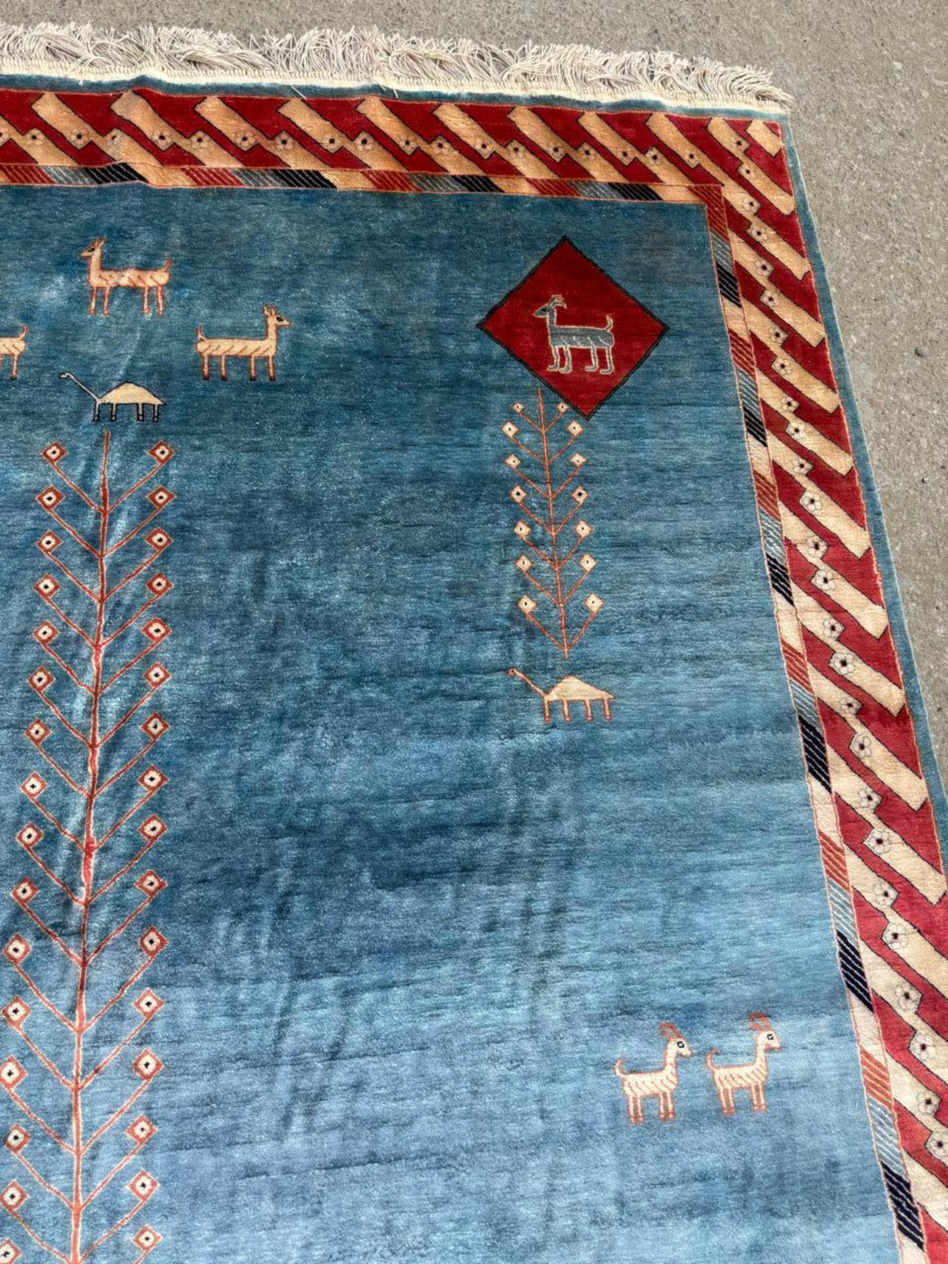 Detail of the luminous champagne-colored silk field and its subtle sheen.

